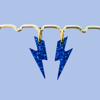 Boucles d’oreilles artisanales L’Atelier Rochelais en forme d’éclair bleu pailleté
